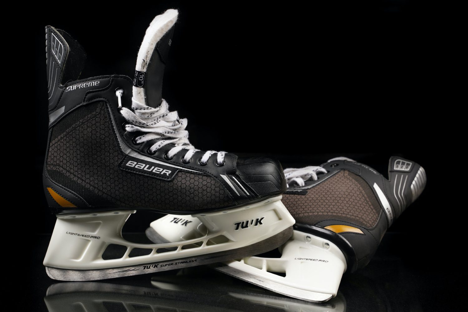 Hockey skating teenage boy with skateboard close up